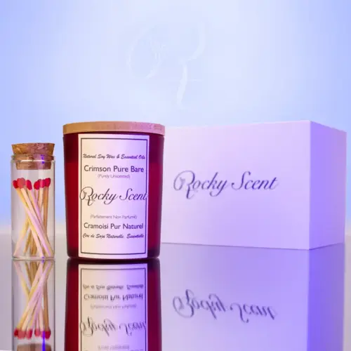 Crimson matte jar unscented candle from Rocky Scent’s Bare Essence line, accompanied by matches and a product box.